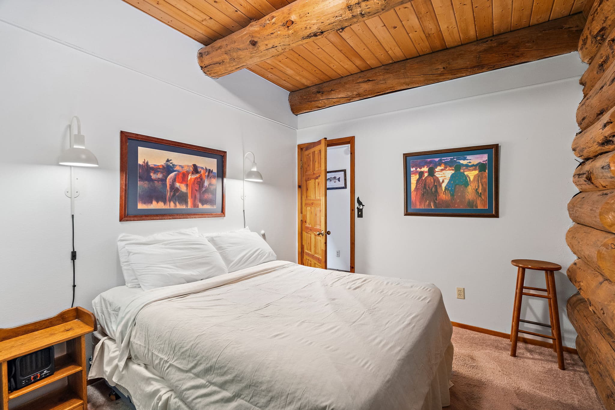 Queen bed and forest views on the main floor.