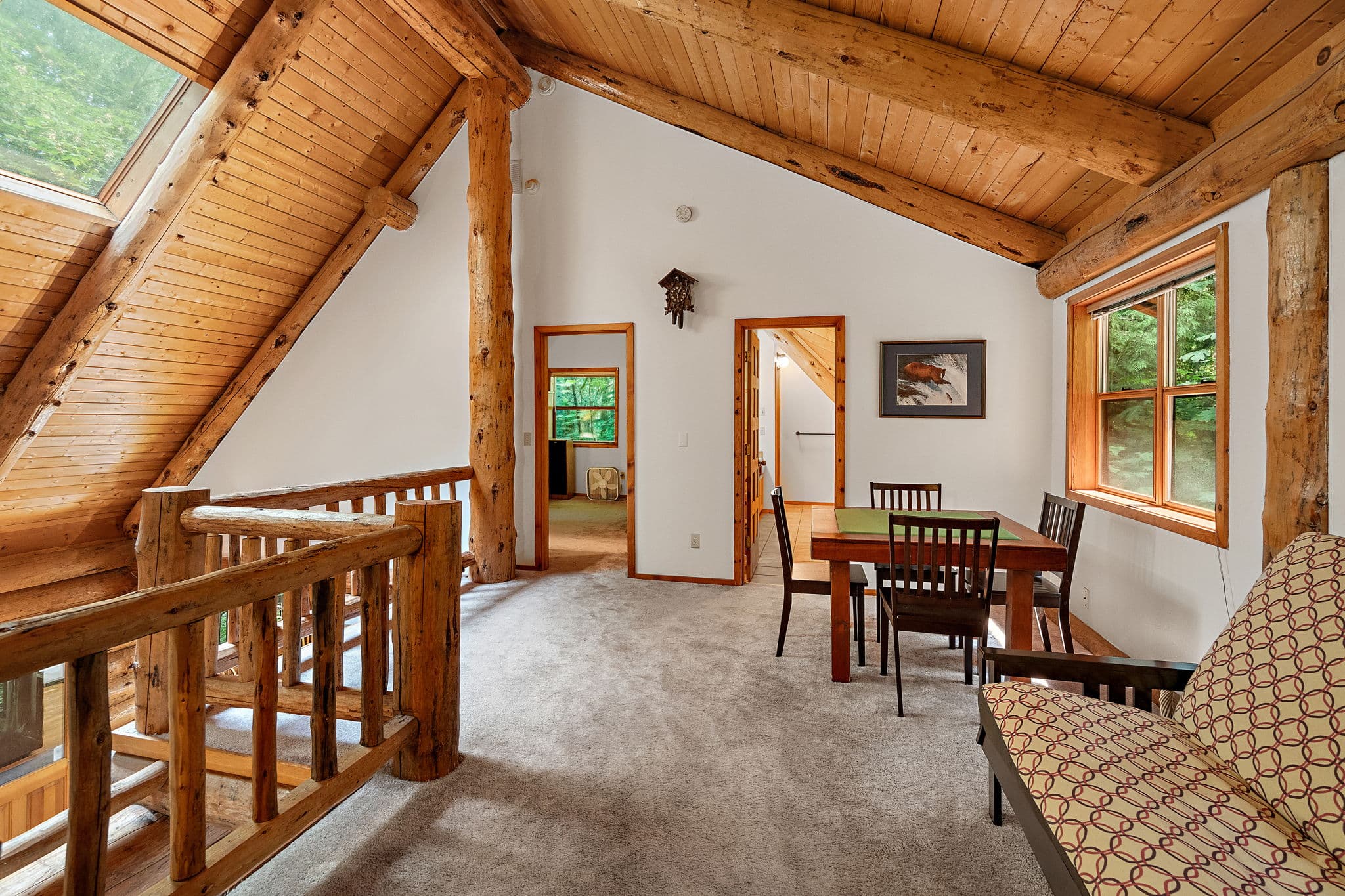 Loft landing with a game table, open to the master and bath.