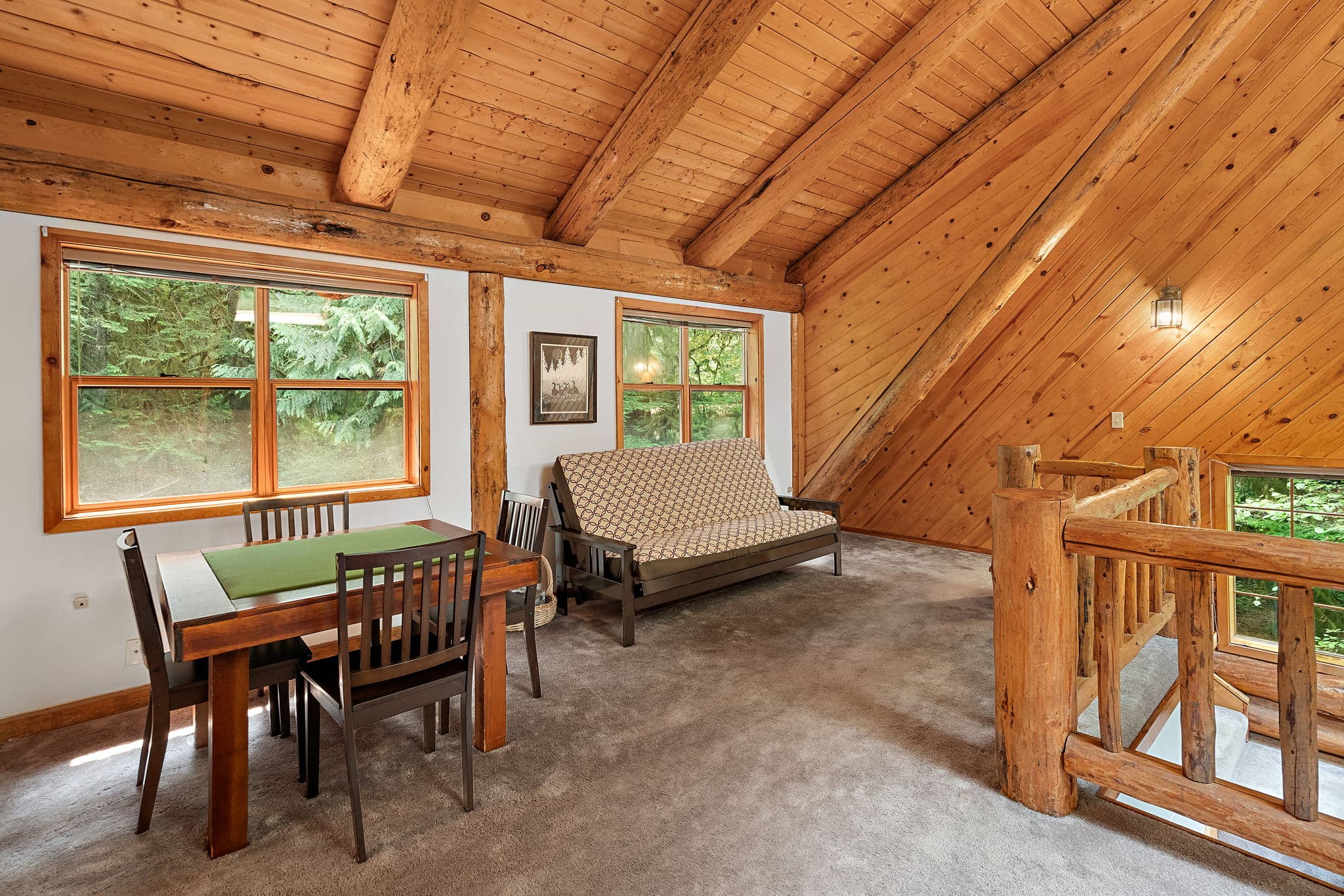 Game table in the loft under the log rafters.