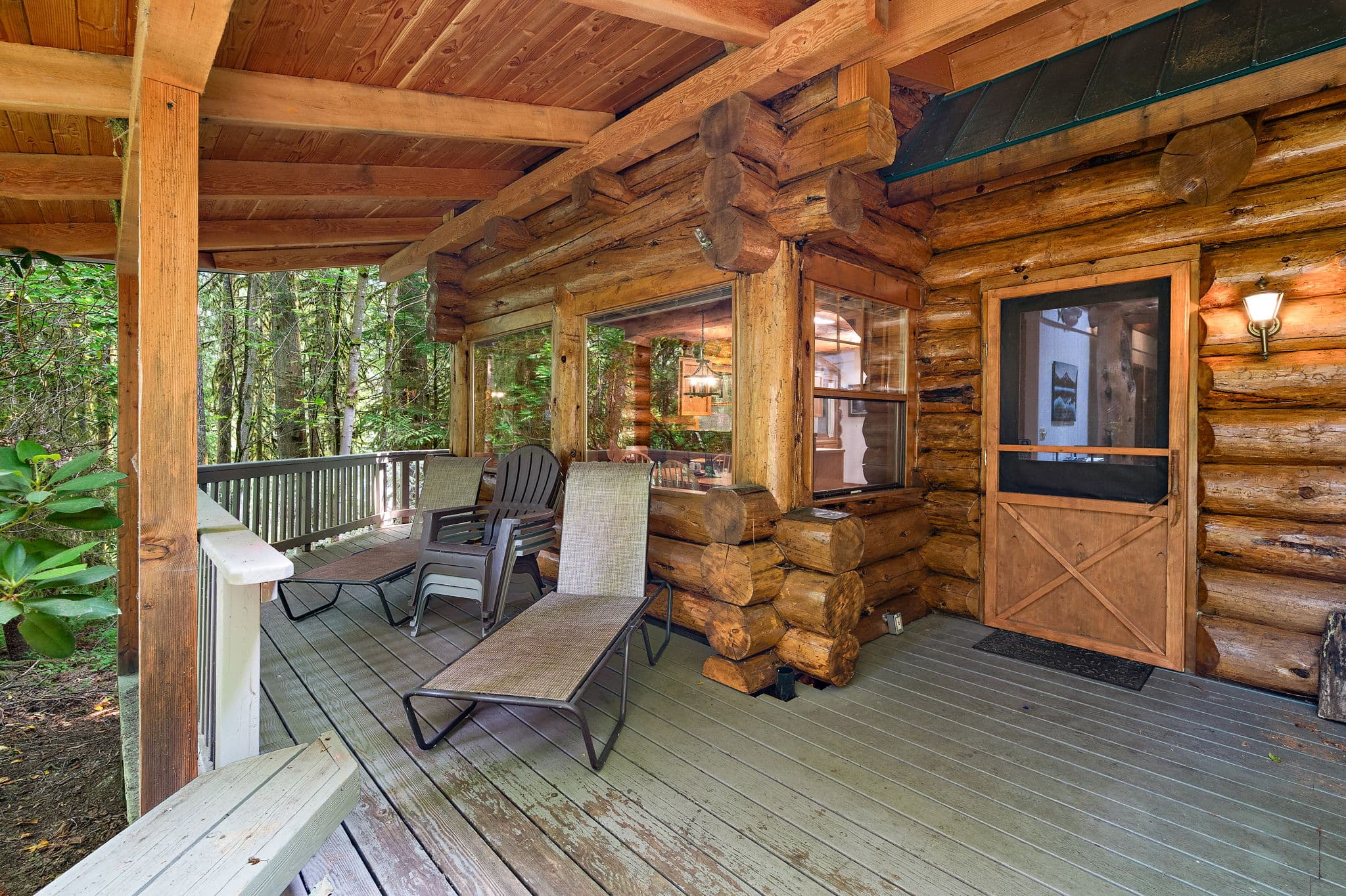 Lounge chairs on the covered porch by the front door.