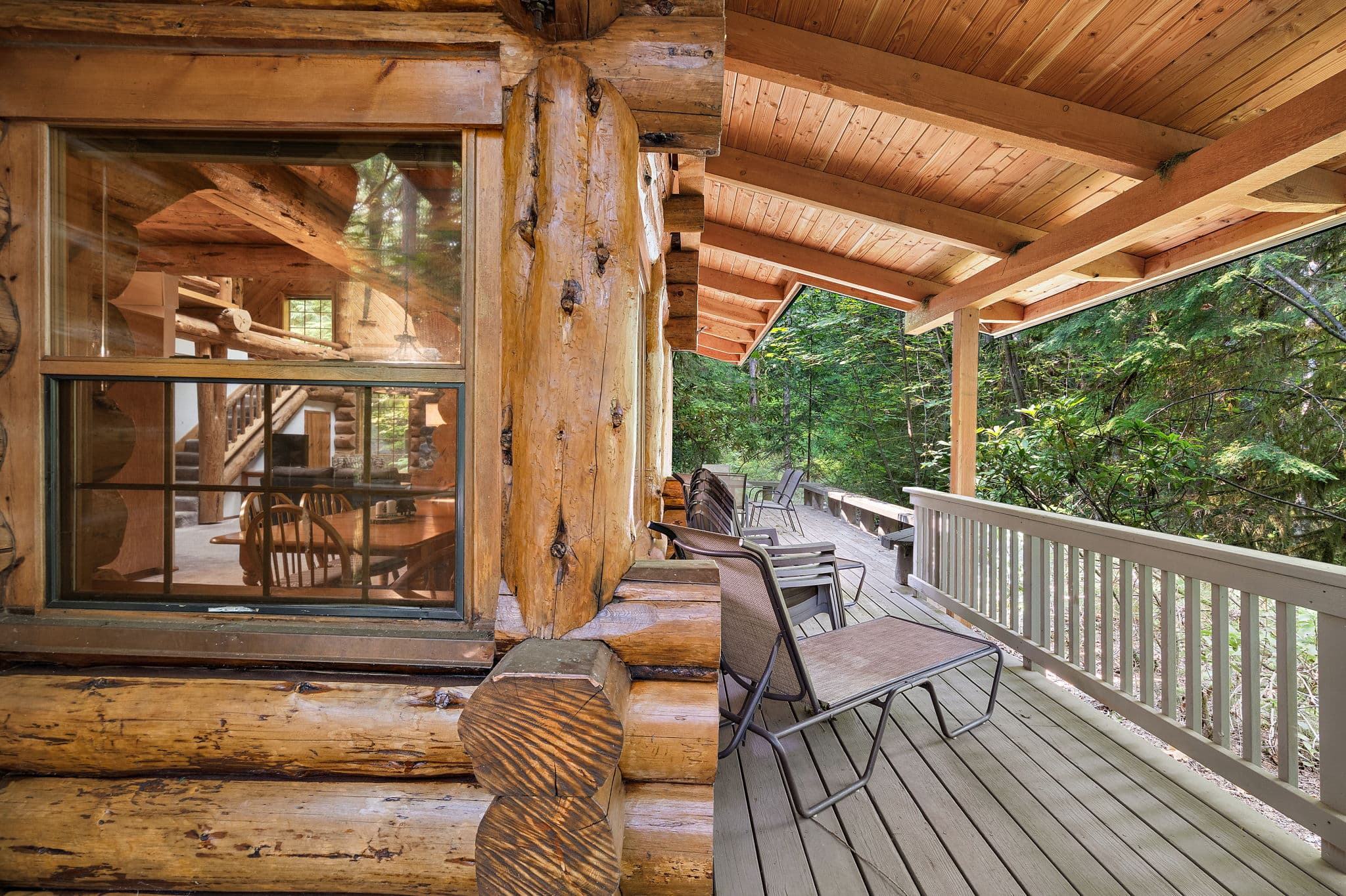 The deck wraps the cabin, with windows into the dining room.