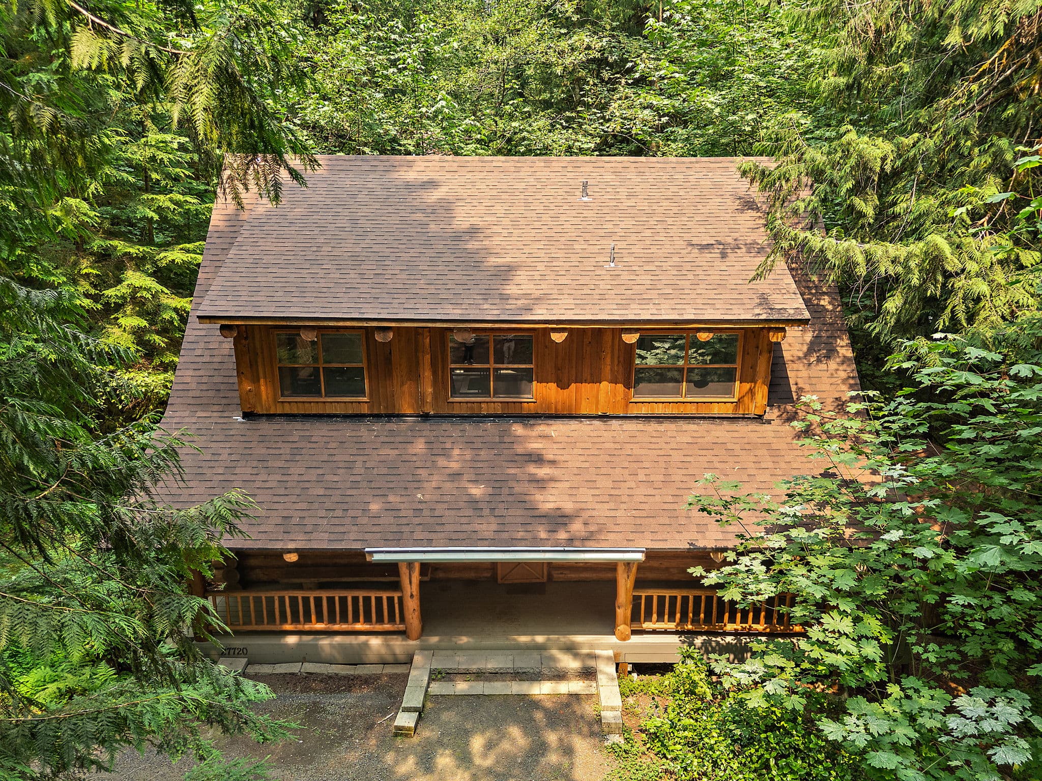 Aerial view of the cabin in its clearing.