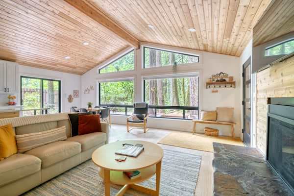 Living room with big forest windows.