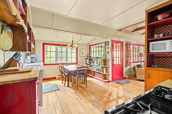Kitchen and dining room with red trim.