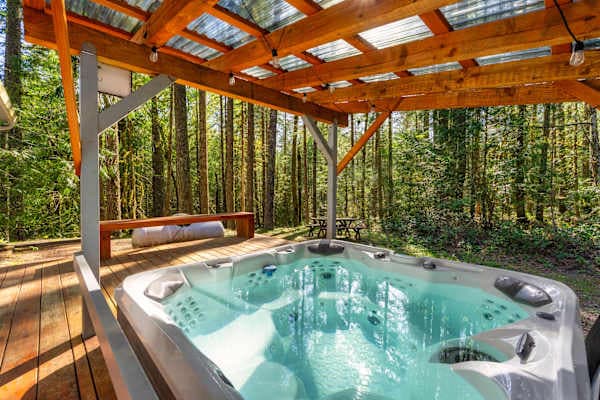 Hot tub under a covered pergola.
