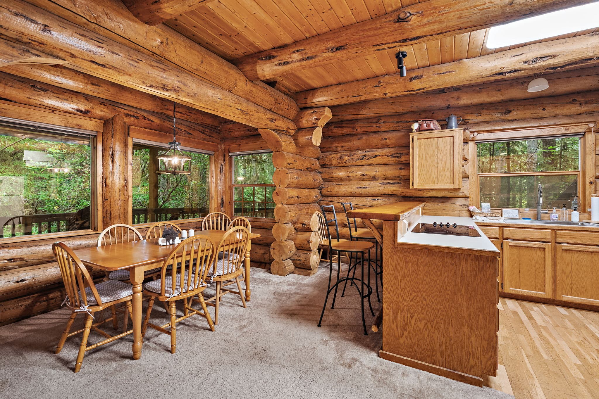 Dining table for six with a breakfast bar off the kitchen.