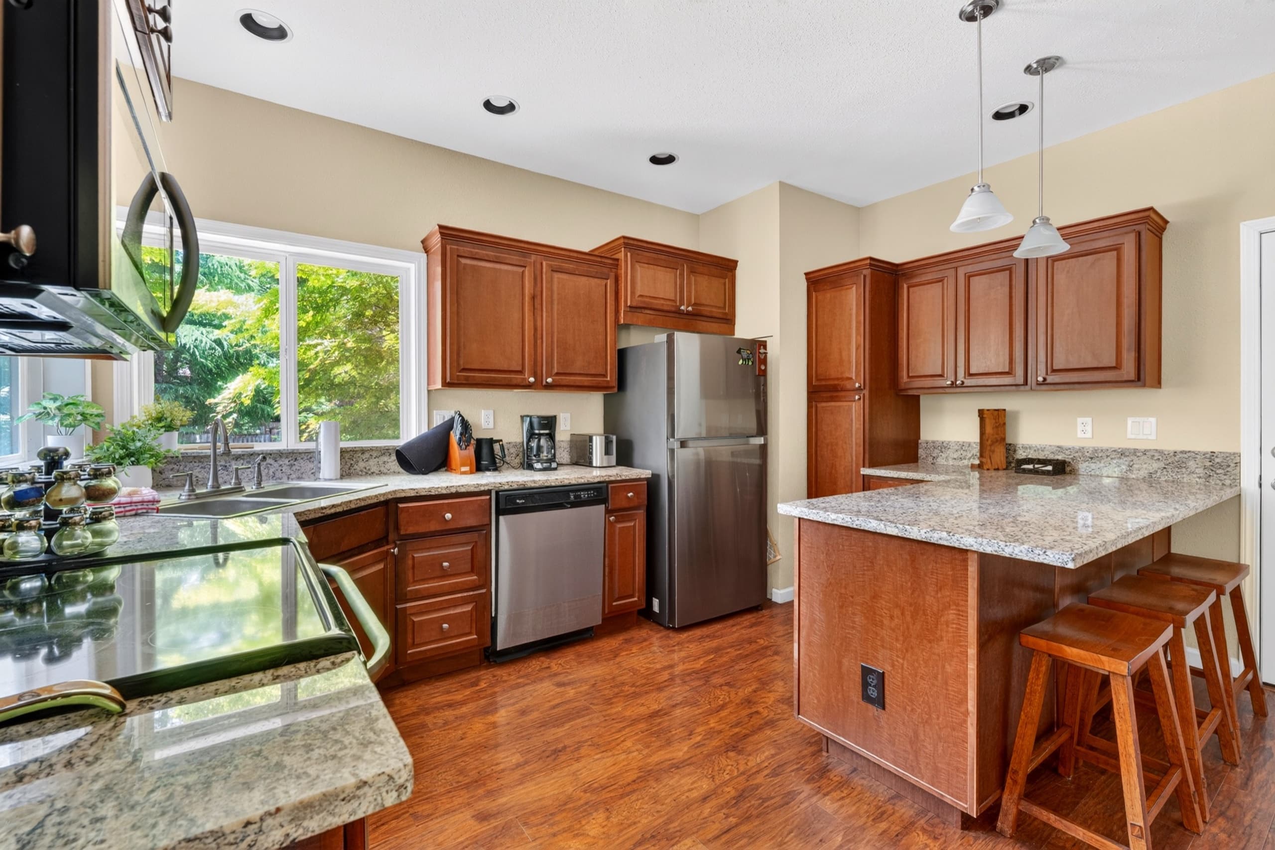 Kitchen with island and stainless appliances.