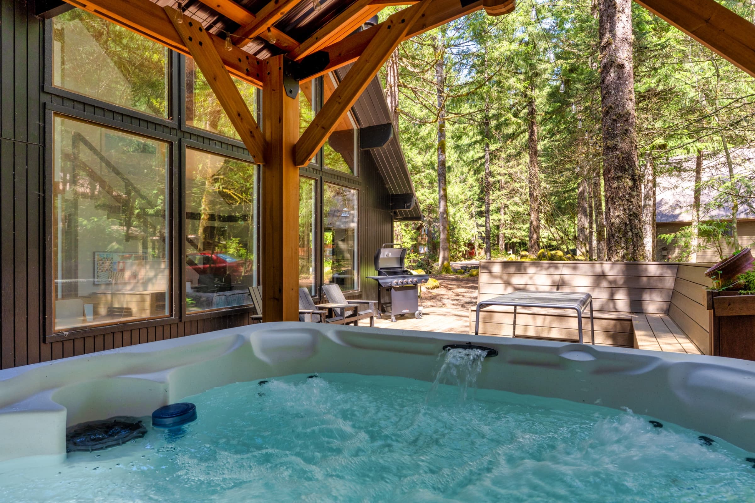 Covered hot tub beside the forest.
